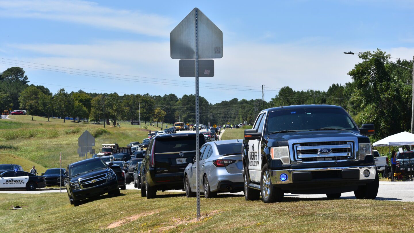 Cars park in a long line as parents arrive to pick up their students after a deadly shooting at Apalachee High School in Barrow County, Georgia, on Sept. 4, 2024.