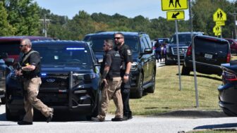 Police officers gather near Apalachee High School after a fatal shooting on Sept. 4, 2024.