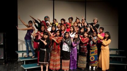 A group of students perform on stage.