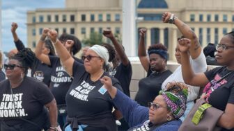 Organizers and supporters of the Trust Black Women initiative, created by reproductive justice group SisterSong, raise their fists at a rally on Saturday, Sept. 28, 2024 outside of the Georgia State Capitol building following recent reports that two Georgia women died after not receiving timely abortion and medical care.