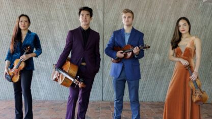 Members of the Vega Quartet stand with their instruments.