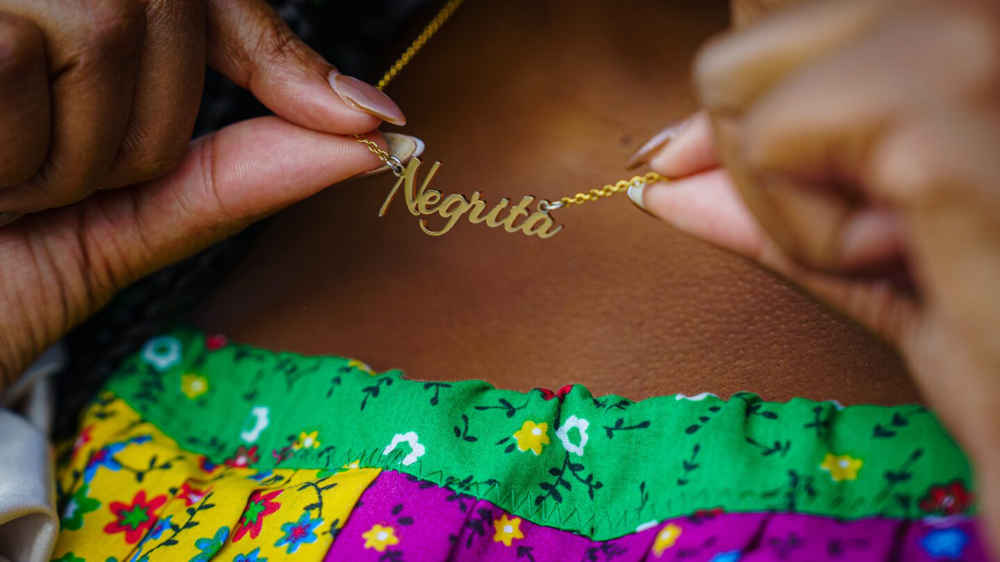 Des Bishop wearing her jewelry, which celebrates Afro Latina culture