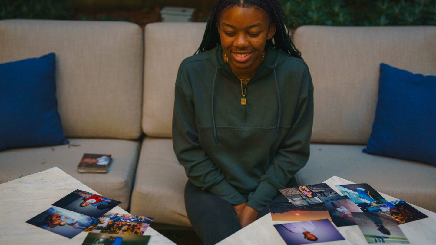 Marina Melendez looks at photos of her family