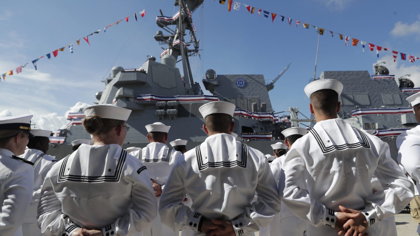 Sailors stand in front of a U.S. Navy guided missile destroyer USS Paul Ignatius at Port Everglades in Florida.