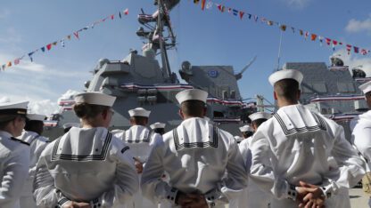 Sailors stand in front of a U.S. Navy guided missile destroyer USS Paul Ignatius at Port Everglades in Florida.