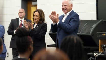 Kamala Harris, left, and Tim Walz, right clap during a band rehearsal.