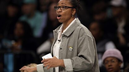 Tanisha Wright, the former coach of the Atlanta Dream, speaks on the sidelines of a game.