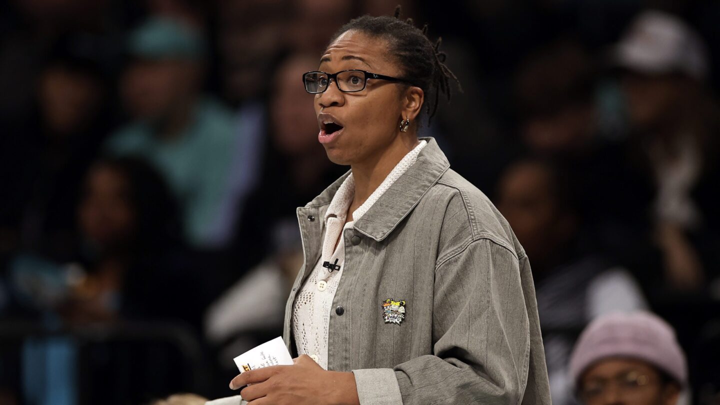 Tanisha Wright, the former coach of the Atlanta Dream, speaks on the sidelines of a game.