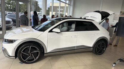 A white Hyundai Ioniq 5 car inside a dealership.