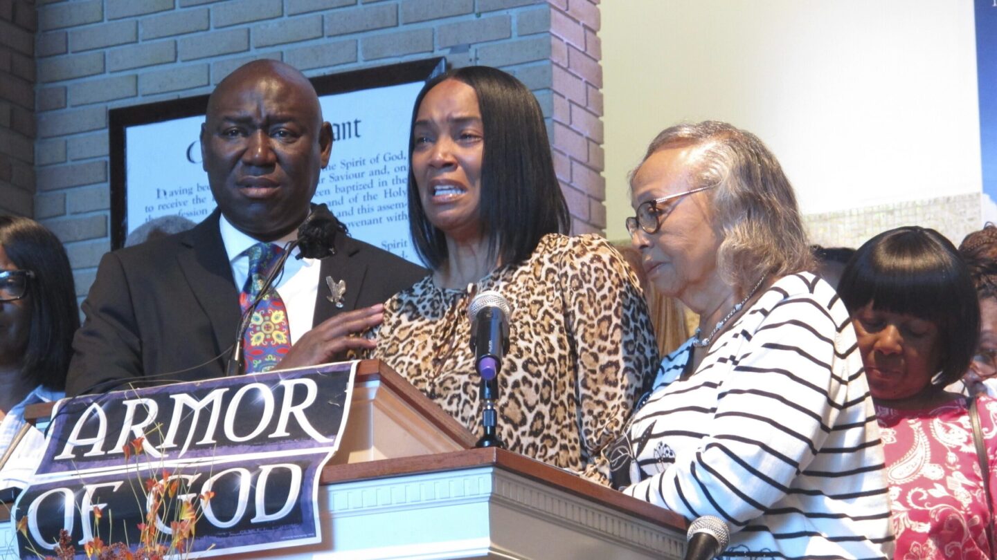 Regina Brinson, center, weeps at a news conference Tuesday, Oct. 22, 2024, while speaking alongside her mother, Katrena Alexander and attorney Ben Crump during a news conference in Jacksonville, Fla.