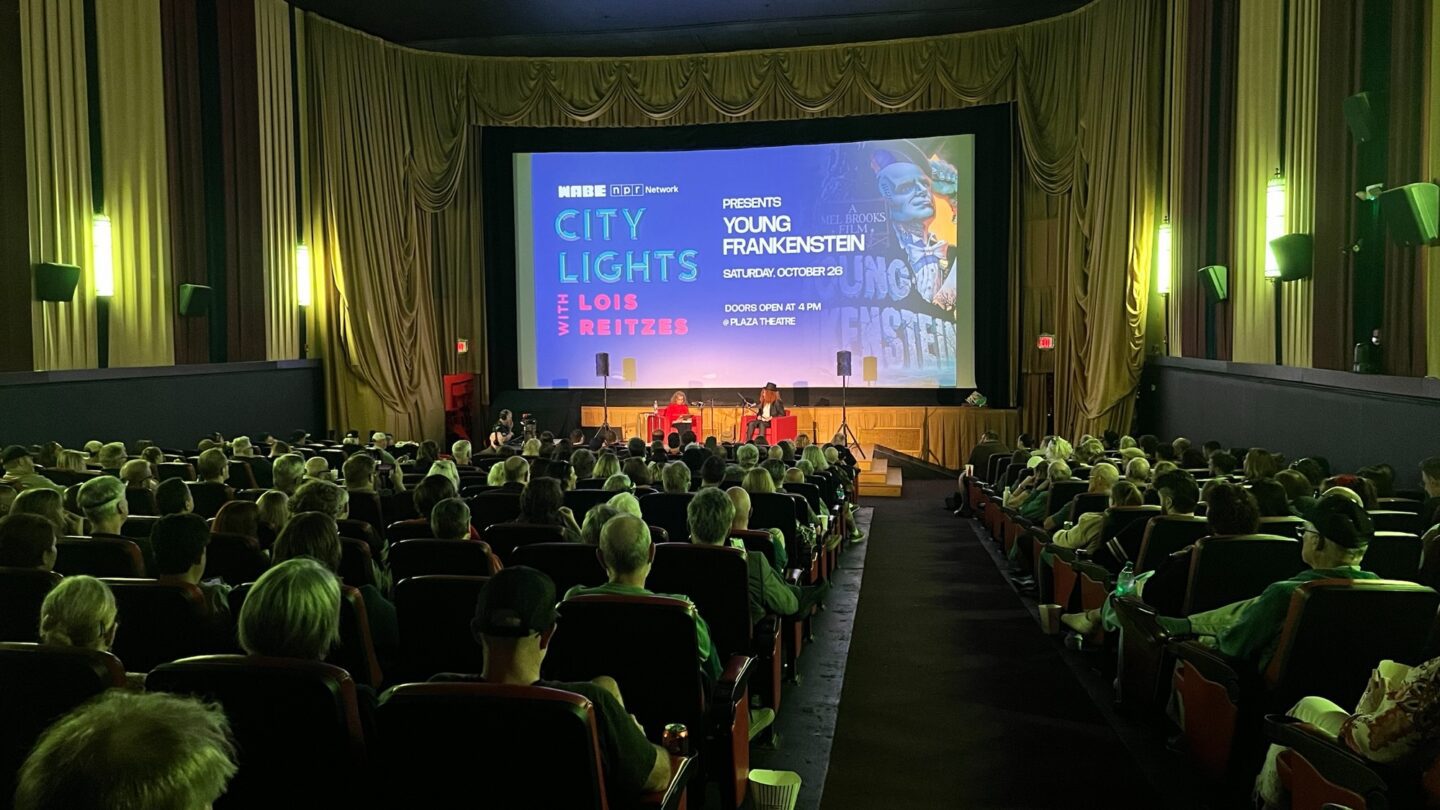 A movie theater with the City Lights logo projected on screen.