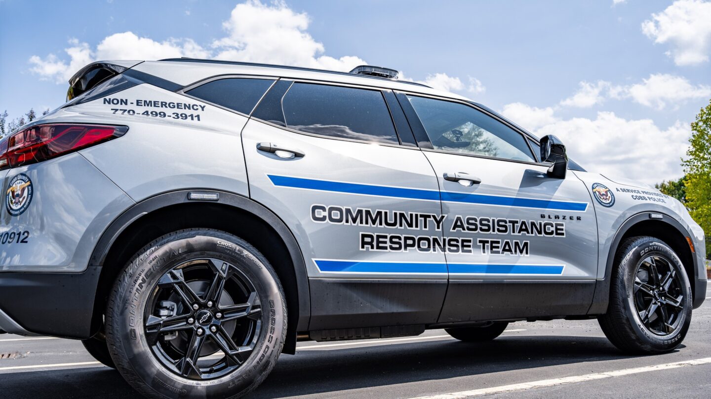 A white police car in the day.