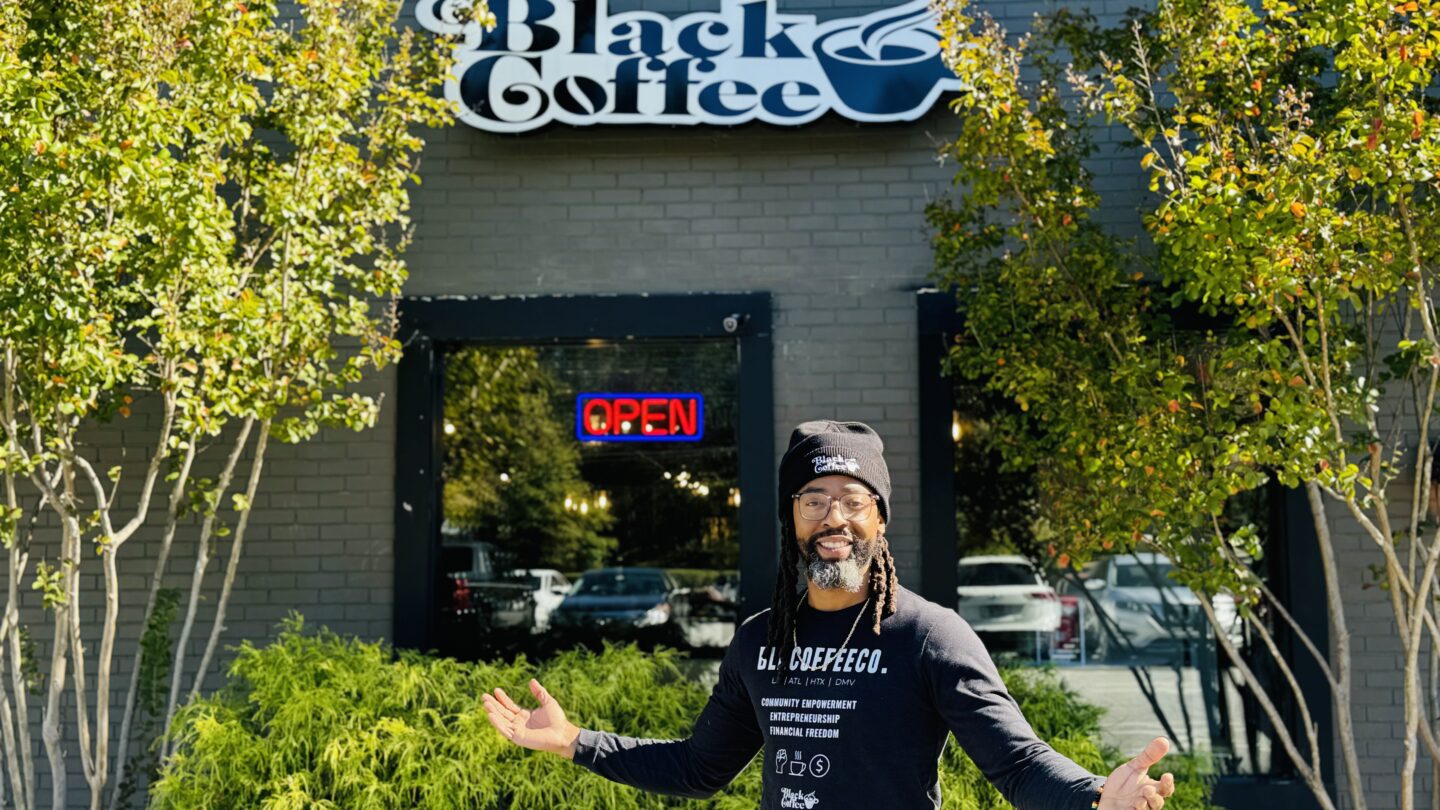 CEO and co-founder Jamin Butler poses in front of Black Coffee Company.