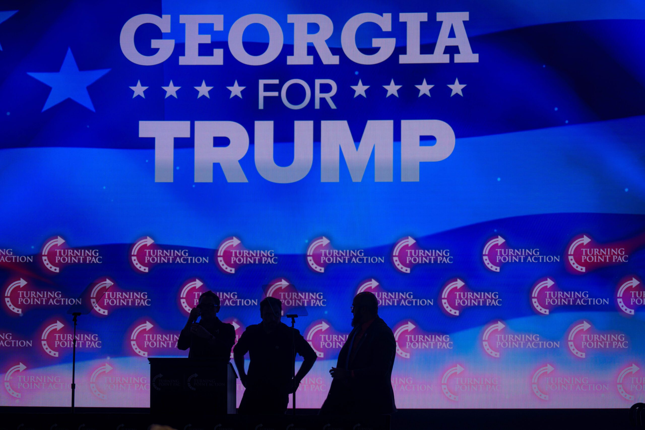 Georgia for Trump is projected in the background of a Gas South Arena rally for Trump.