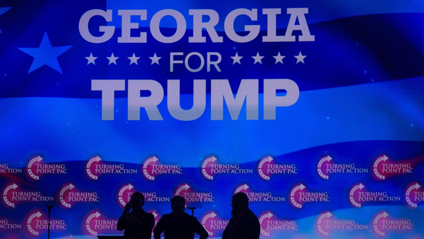 Georgia for Trump is projected in the background of a Gas South Arena rally for Trump.