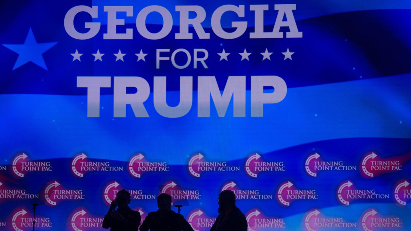 Georgia for Trump is projected in the background of a Gas South Arena rally for Trump.