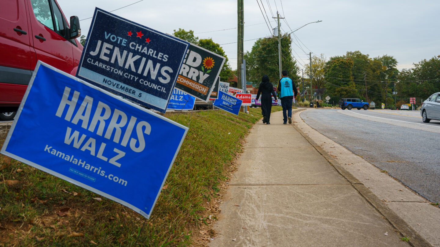 Campaign signs line the streets near the Clarkston Branch of the DeKalb County Public Library on the last day of early voting, Friday, November 1, 2024.