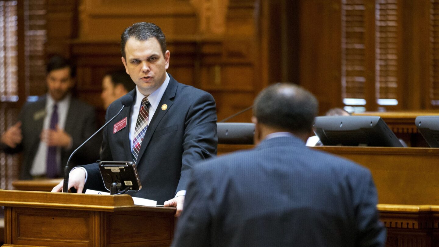 Christian Coomer, left, answers a question from Rep. Al Williams, D-Midway, during a legislation debate on the House floor, March 25, 2015, in Atlanta.