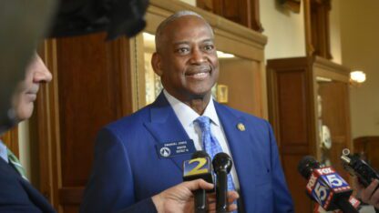 Emanuel Jones talks with reporters in the Georgia State Capitol.