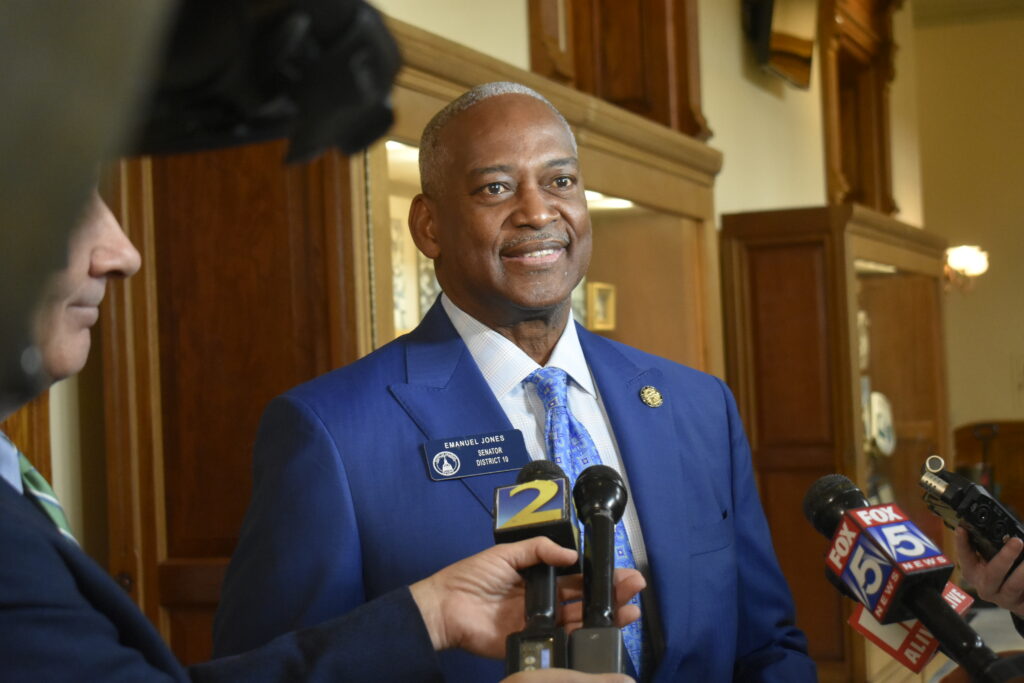 Emanuel Jones talks with reporters in the Georgia State Capitol.