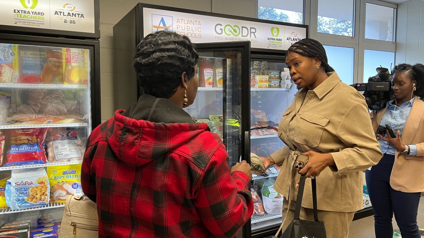 Leandre Bigby and Jasmine Crowe-Houston stand near two freezers at the new Goodr store.