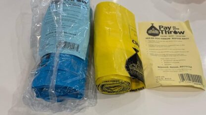 A roll of blue bags and a roll of yellow bags.