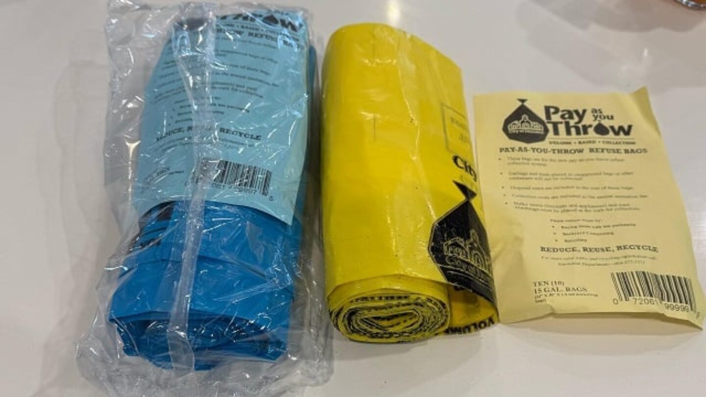 A roll of blue bags and a roll of yellow bags.