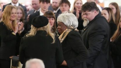 Amy Carter greets Mary Prince during the funeral service for former President Jimmy Carter at Maranatha Baptist Church.