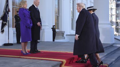 President Joe Biden and First Lady Jill Biden stand on the steps of the White House, facing Donald Trump and Melania Trump as they make their way up the steps.