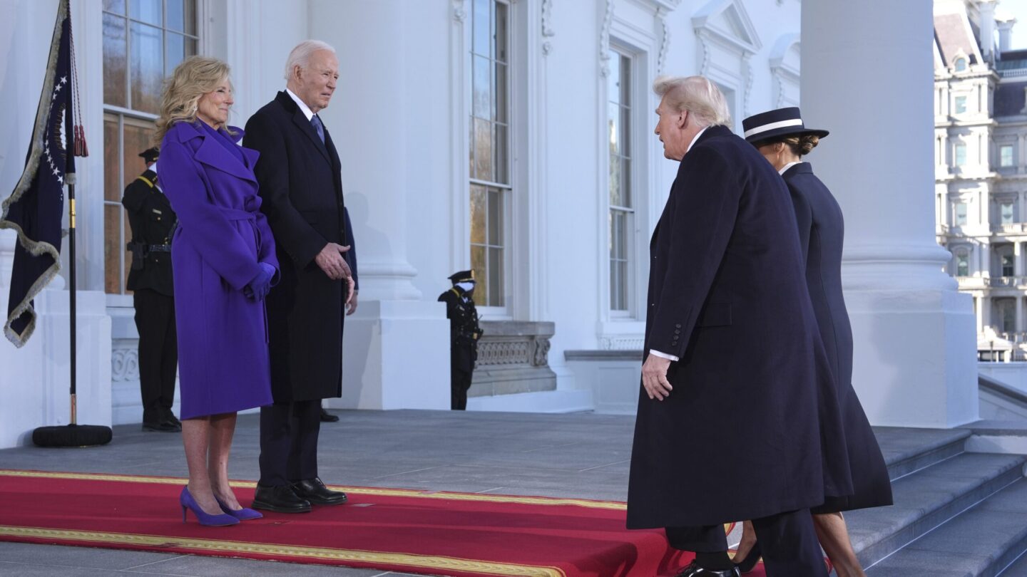 President Joe Biden and First Lady Jill Biden stand on the steps of the White House, facing Donald Trump and Melania Trump as they make their way up the steps.